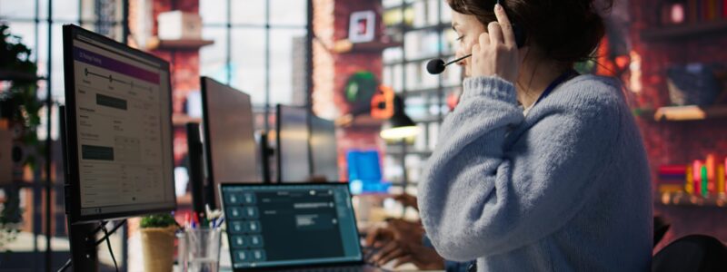 Customer support agent arriving at work, entering office, assisting customers with inquiries. Call center employee sitting down at PC desk, starting account management tasks, camera B