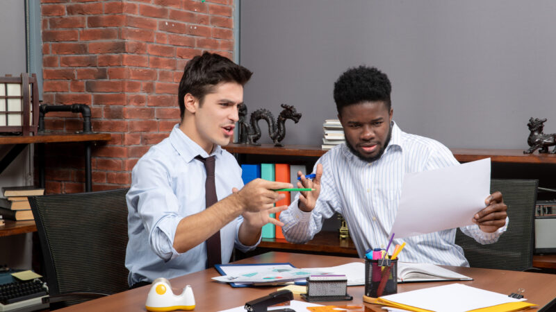 front-view-two-hardworking-businessmen-satisfying-working-together